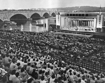Crowd on "Watergate" steps watching performance on barge at edge of Potomac River (ca. 1956). Burdell Wright, Jr. Photograph Collection